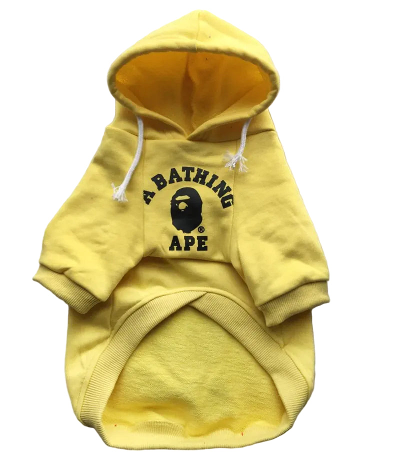 Yellow hoodie with a graphic design on a textured surface