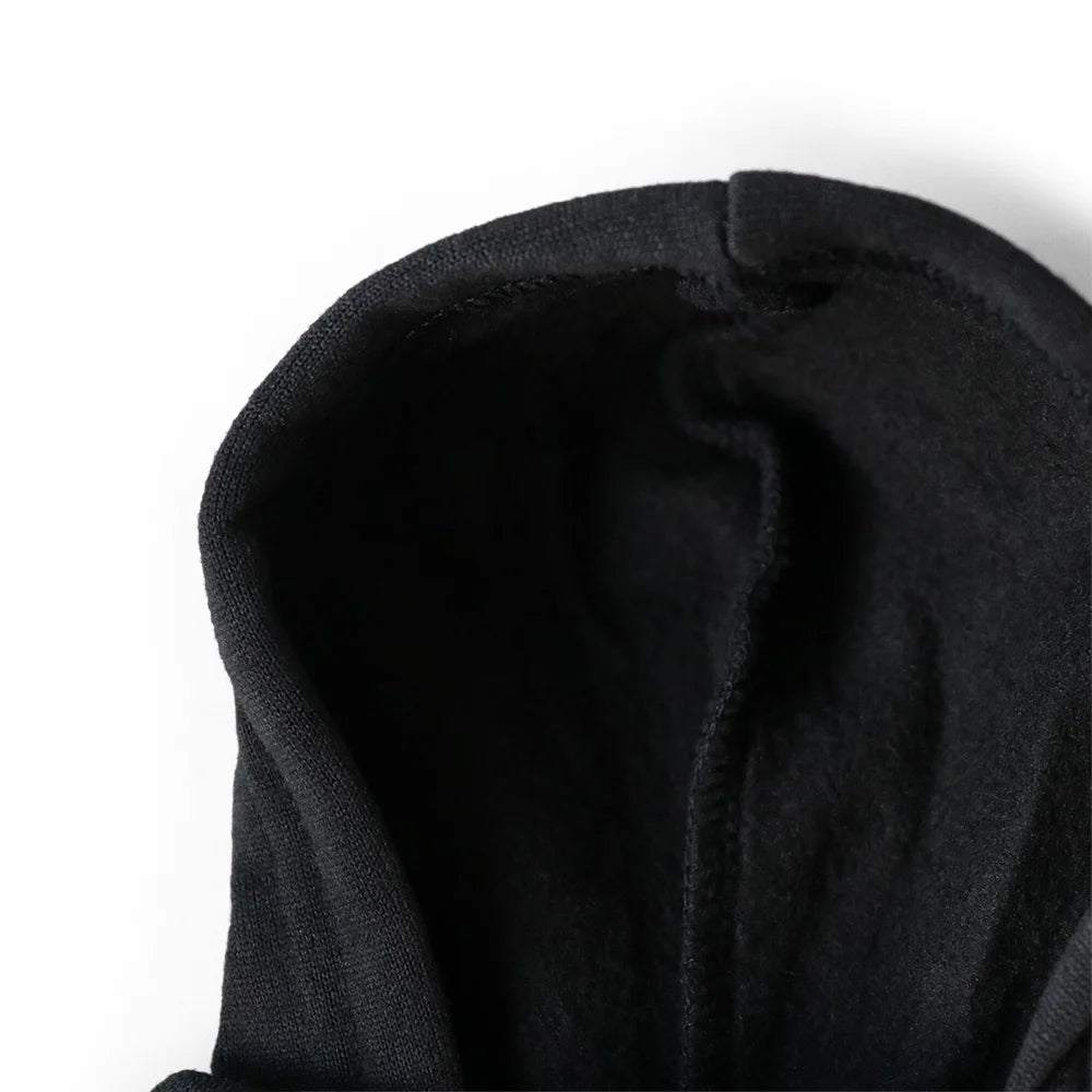 Close-up of a black hooded garment on a white background