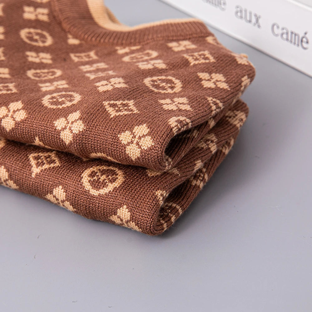 Folded brown fabric with a pattern on a gray surface