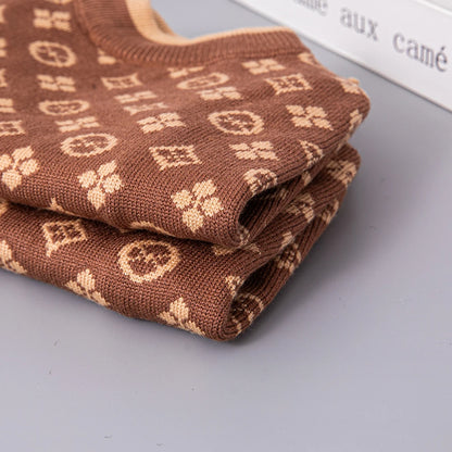 Folded brown fabric with a pattern on a gray surface