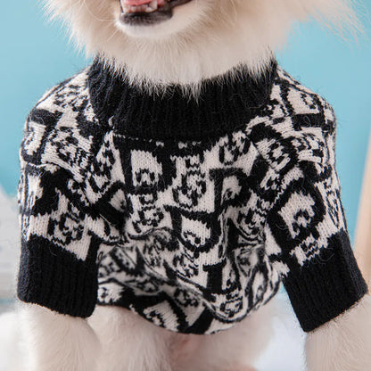 Dog wearing a black and white patterned sweater against a blue background