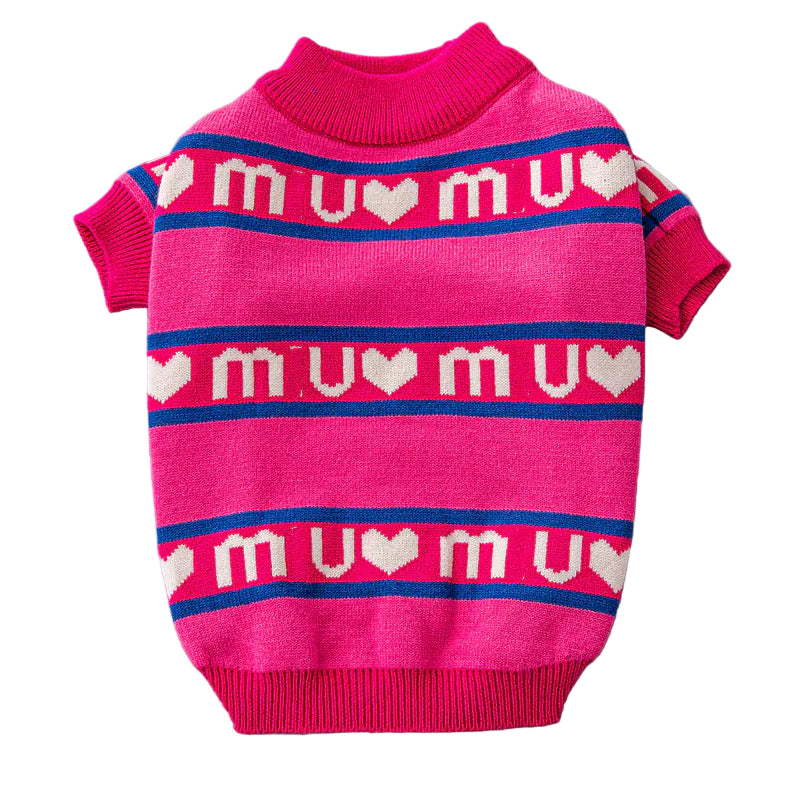 Pink dog sweater with 'mu mu' pattern on a gray surface