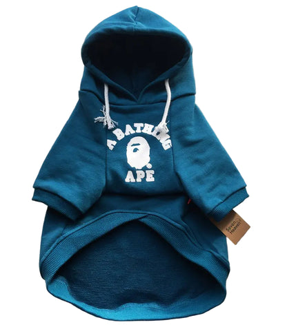 Blue hoodie with a white logo on a textured gray surface