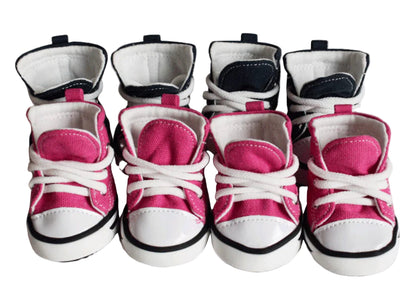 Set of pink and white baby shoes on a white background