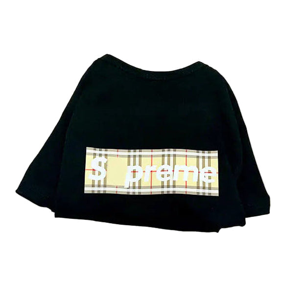 Black t-shirt with plaid design and 'Supreme' logo on a beige tote bag with brown handles.