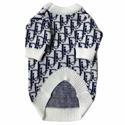 White sweater with blue pattern on a white fluffy surface