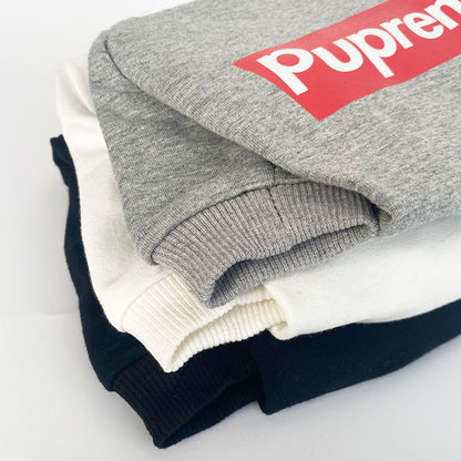 Stack of folded sweaters with a visible brand logo on a light background