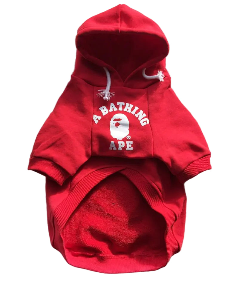 Red hoodie with 'A Bathing Ape' logo on a textured surface