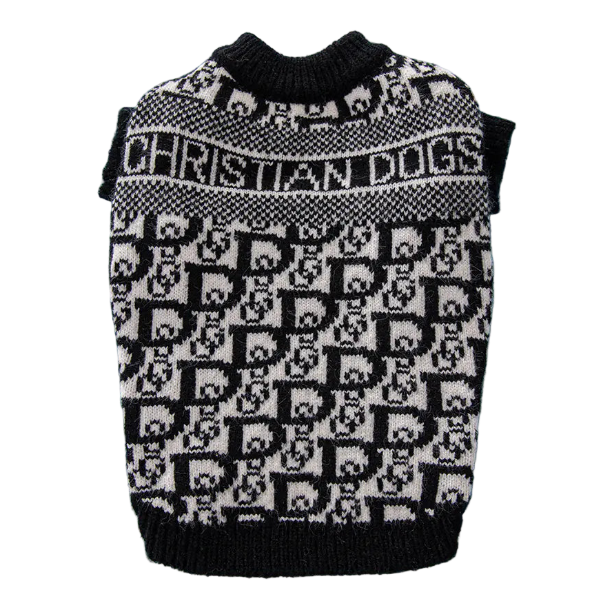 Black and white patterned dog sweater on a blue surface with a book in the background