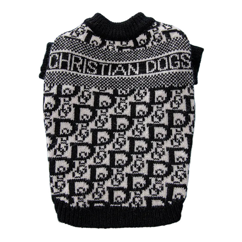 Black and white patterned dog sweater on a blue surface with a book in the background