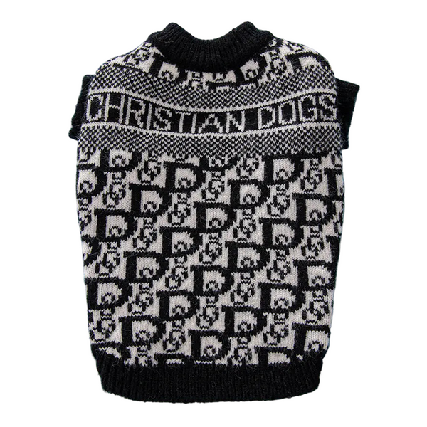 Black and white patterned dog sweater on a blue surface with a book in the background